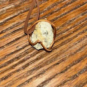 Hand wrapped Tennessee rock wrapped in copper wit leather rope.